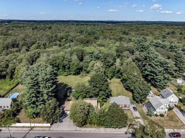 an aerial view of a houses with a yard