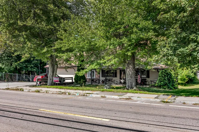 a front view of multiple houses with yard
