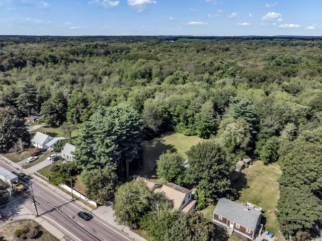 an aerial view of a residential houses with outdoor space