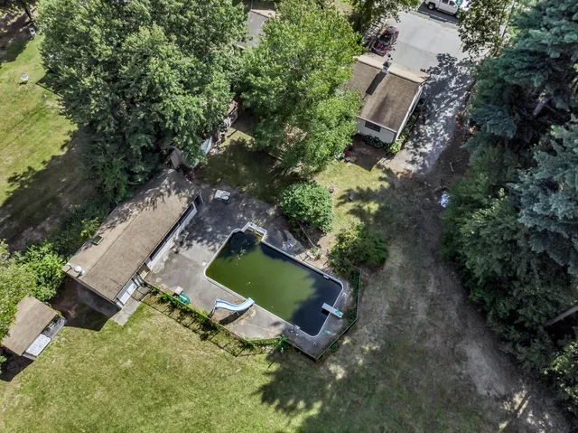 an aerial view of a house with a yard and trees