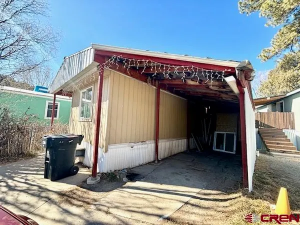 a kitchen with granite countertop a refrigerator stove top oven and sink