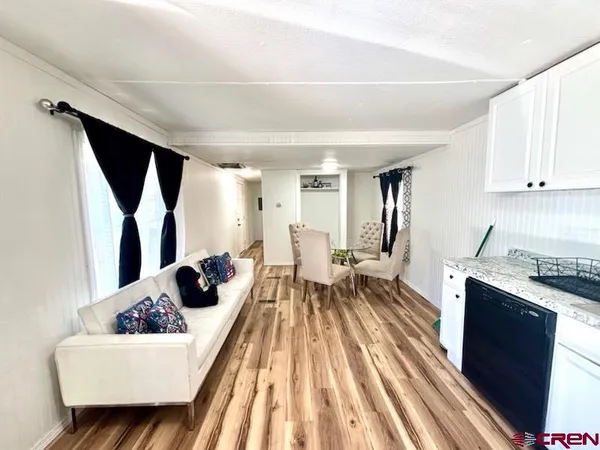 a kitchen with a sink window and stainless steel appliances