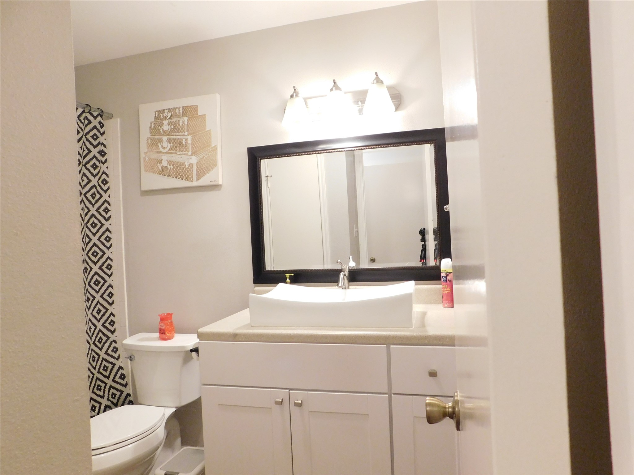 10101 South Gessner Road, Unit 912 Houston, TX 77071 - Photo 34 of 47 a bathroom with a sink a toilet and a mirror