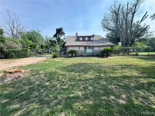 a big house with a big yard and large trees