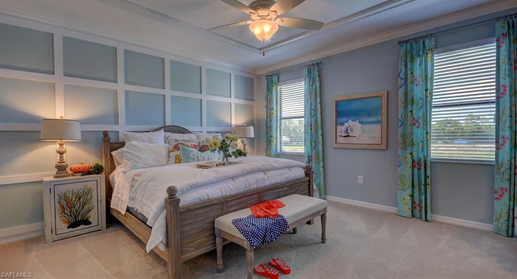 2767 Citrus Street Naples, FL 34120 - Photo 11 of 27 a bedroom with a bed and a chandelier
