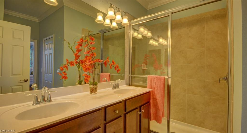 2767 Citrus Street Naples, FL 34120 - Photo 13 of 27 a bathroom with a double vanity sink and a mirror