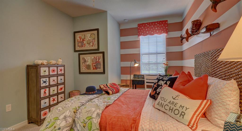 2767 Citrus Street Naples, FL 34120 - Photo 15 of 27 a bedroom with a bed a dresser and a book shelf