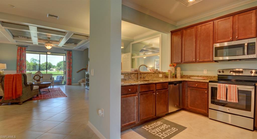 2767 Citrus Street Naples, FL 34120 - Photo 2 of 27 a kitchen with stainless steel appliances granite countertop a stove sink and cabinets