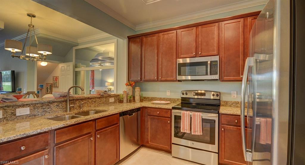 2767 Citrus Street Naples, FL 34120 - Photo 3 of 27 a kitchen with stainless steel appliances granite countertop a stove a sink and a microwave
