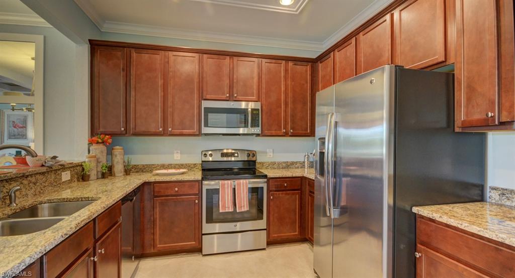 2767 Citrus Street Naples, FL 34120 - Photo 4 of 27 a kitchen with stainless steel appliances granite countertop a refrigerator stove and sink
