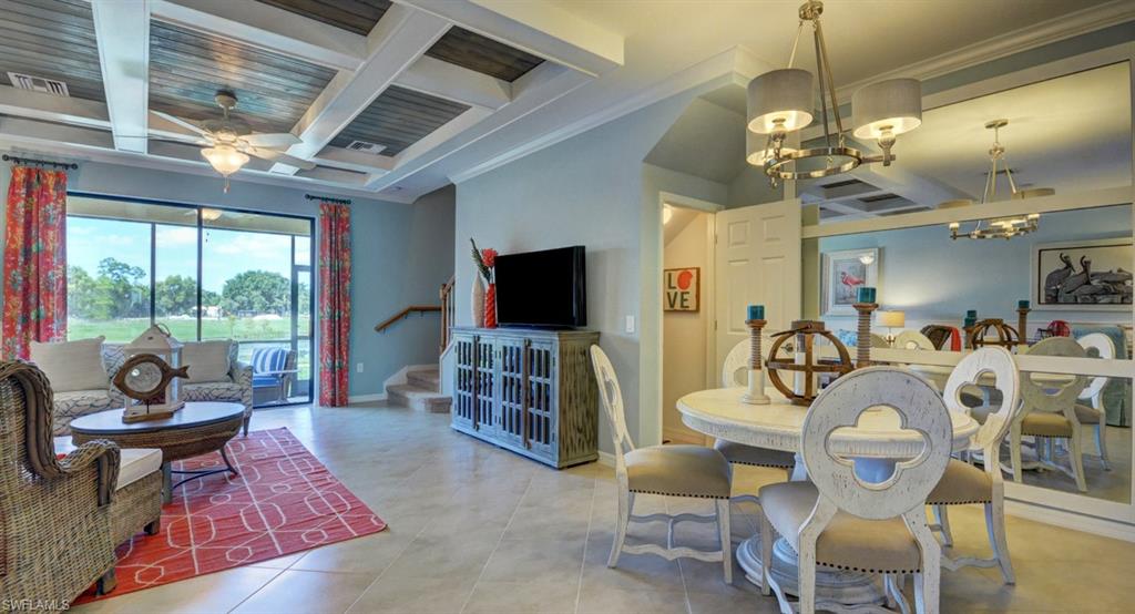 2767 Citrus Street Naples, FL 34120 - Photo 6 of 27 a living room with furniture a flat screen tv and a floor to ceiling window