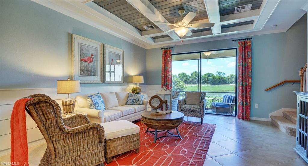 2767 Citrus Street Naples, FL 34120 - Photo 8 of 27 a living room with furniture a fireplace and a large window