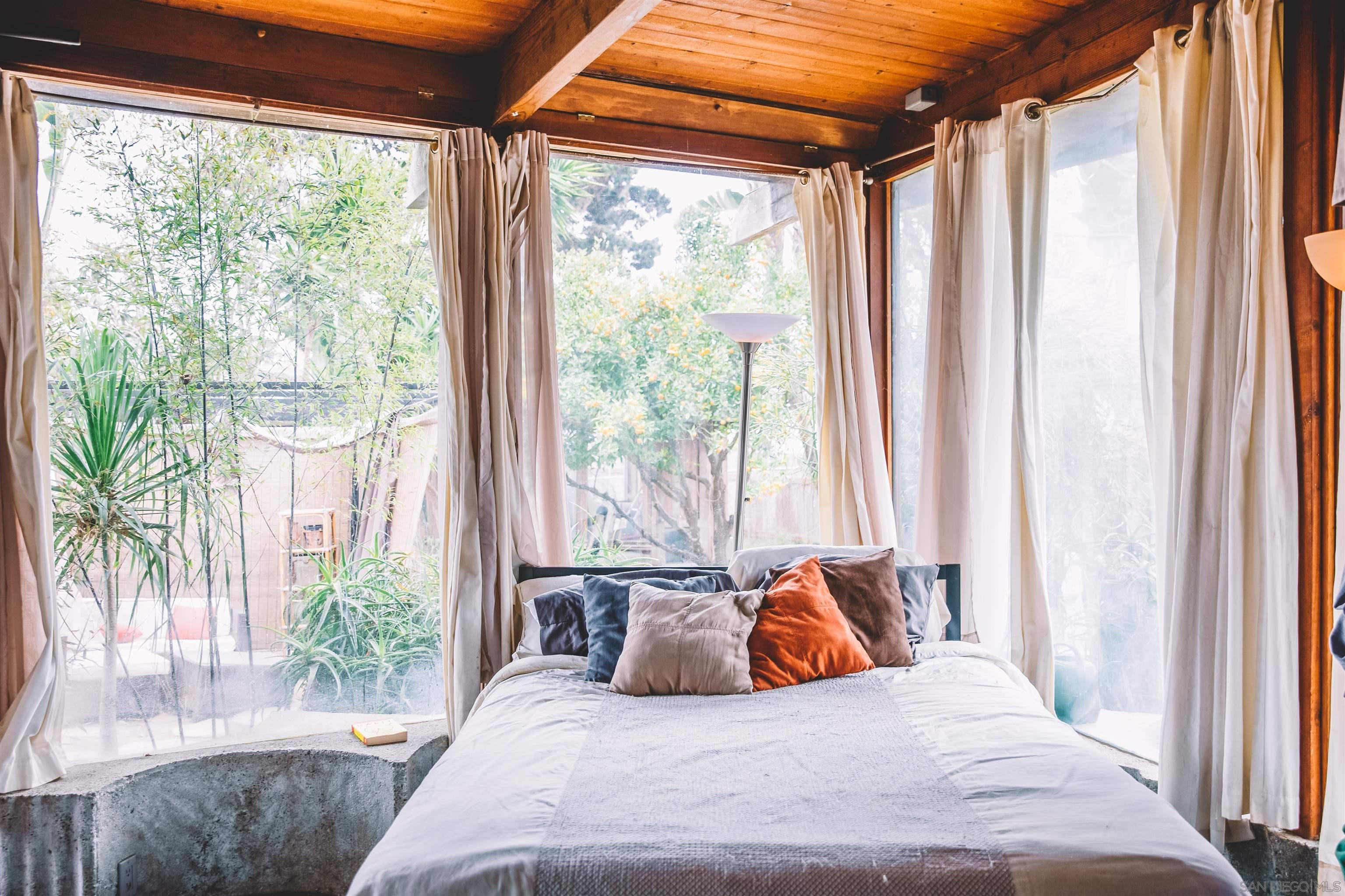 1347 Summit Avenue, Unit MIDDLE Encinitas, CA 92007 - Photo 13 of 19 a bedroom with a bed and a large window