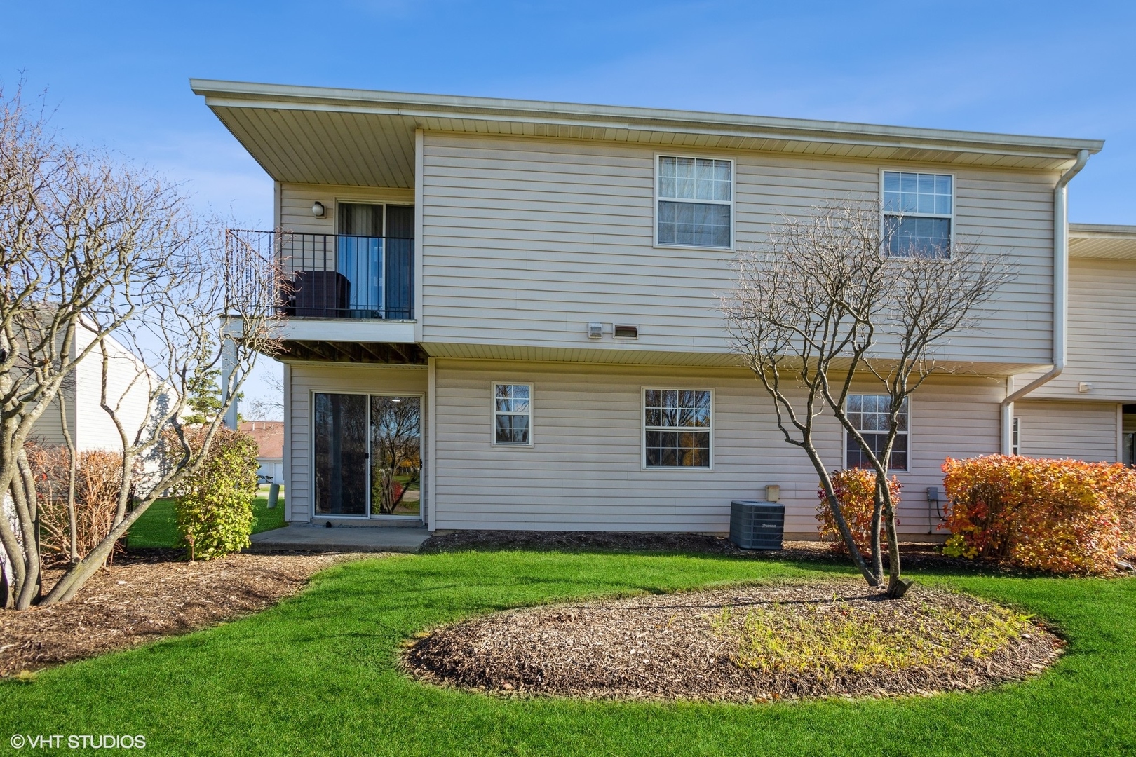 117 Gant Circle, Unit D Streamwood, IL 60107 - Photo 14 of 16 a front view of a house with garden