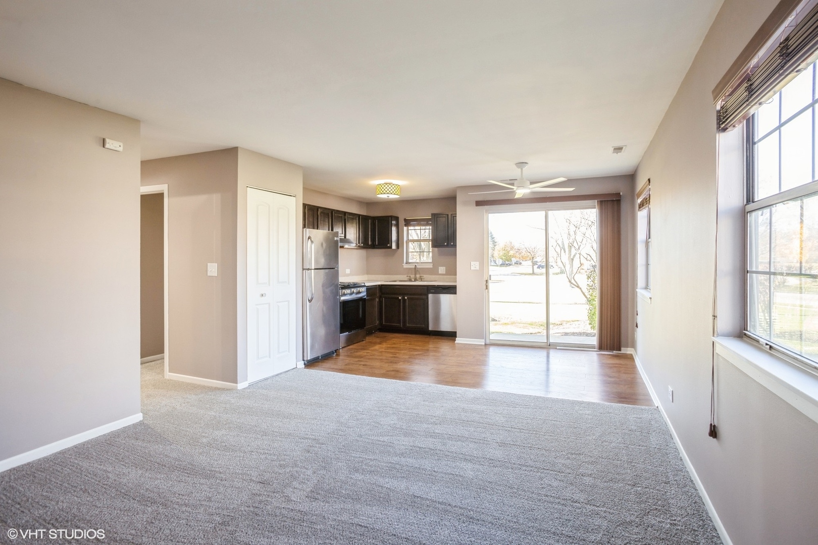 117 Gant Circle, Unit D Streamwood, IL 60107 - Photo 2 of 16 a view of an empty room with a kitchen and a window