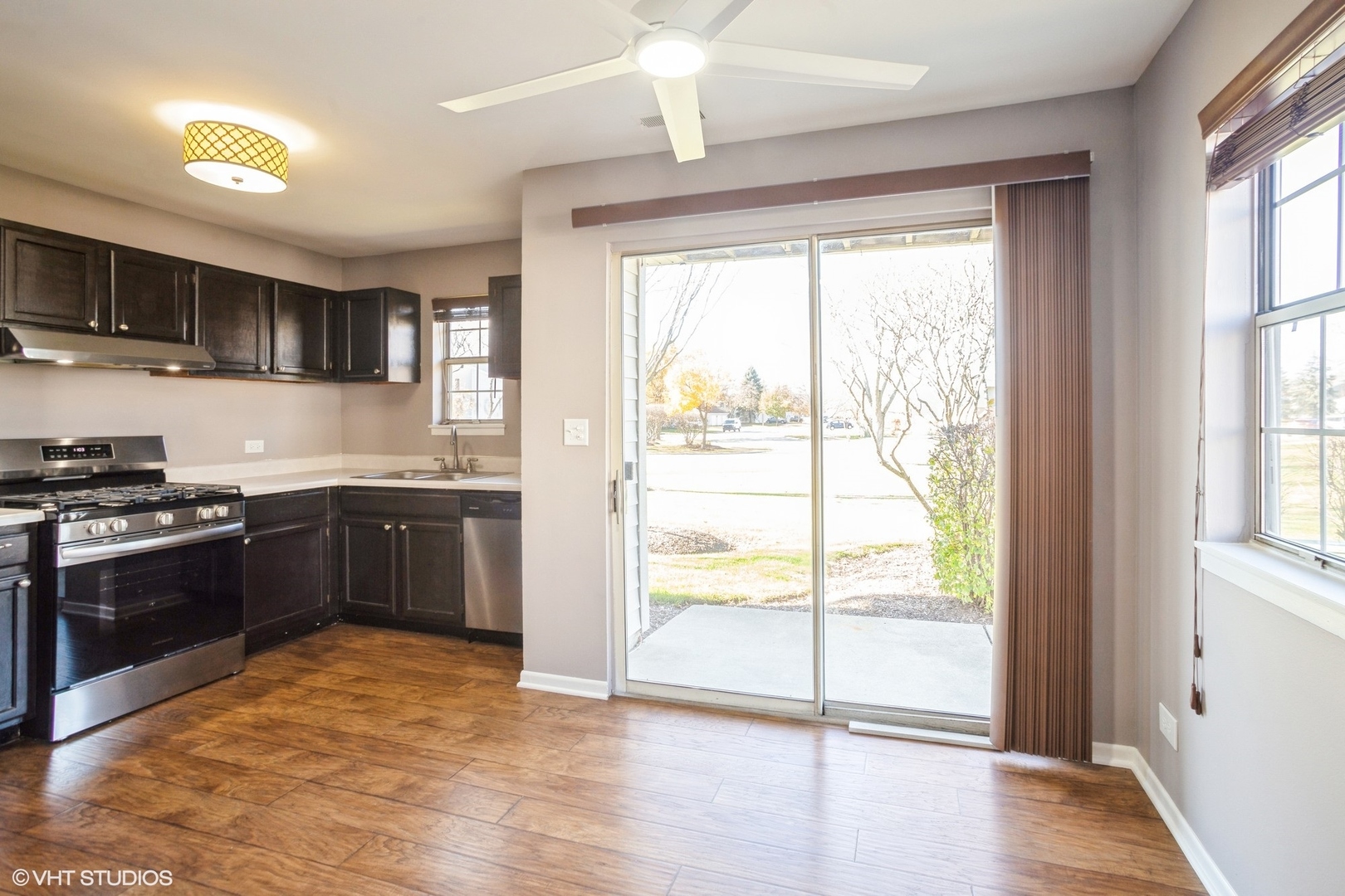 117 Gant Circle, Unit D Streamwood, IL 60107 - Photo 4 of 16 a kitchen with stainless steel appliances granite countertop a stove a sink and a refrigerator