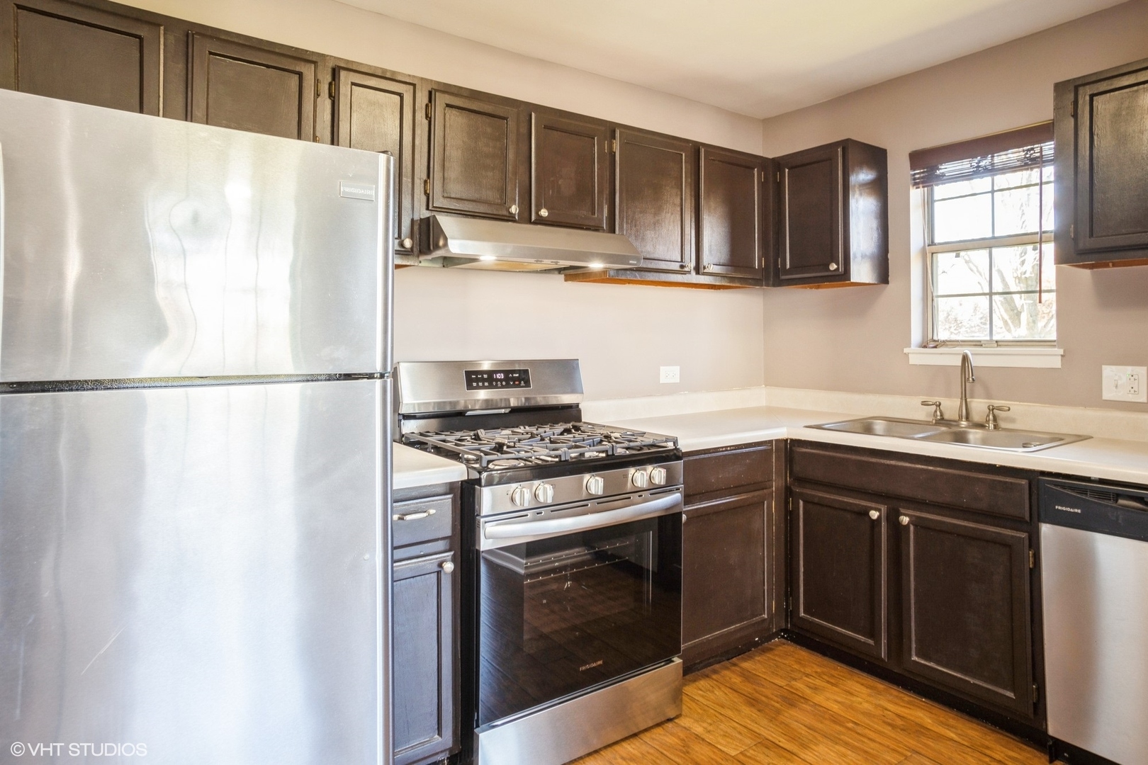 117 Gant Circle, Unit D Streamwood, IL 60107 - Photo 5 of 16 a kitchen with a stove a sink and a refrigerator