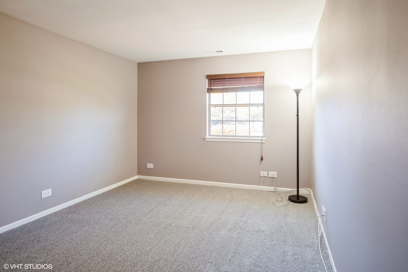 117 Gant Circle, Unit D Streamwood, IL 60107 - Photo 7 of 16 an empty room with windows