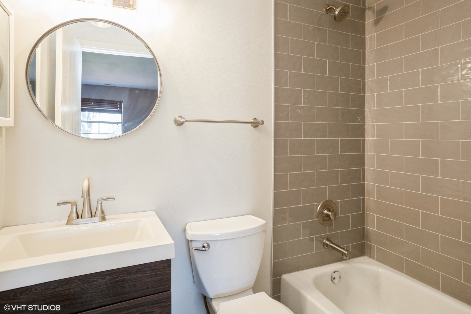 117 Gant Circle, Unit D Streamwood, IL 60107 - Photo 8 of 16 a bathroom with a sink a toilet and mirror