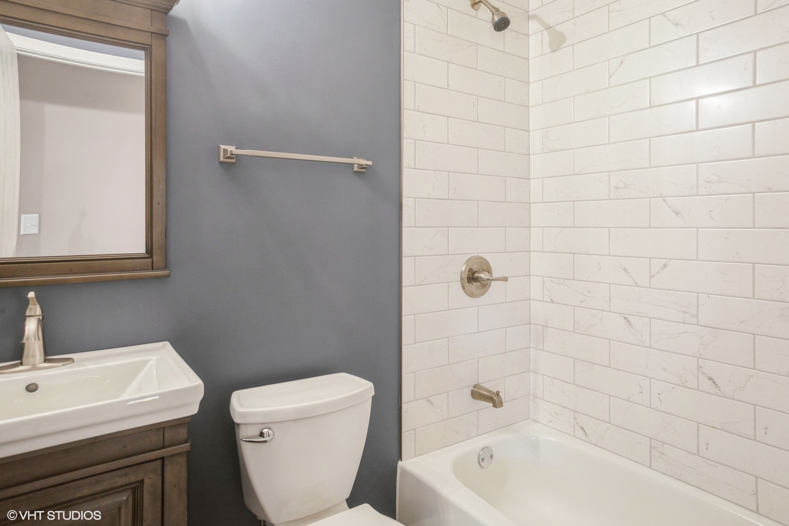 117 Gant Circle, Unit D Streamwood, IL 60107 - Photo 10 of 16 a bathroom with a sink a toilet and shower