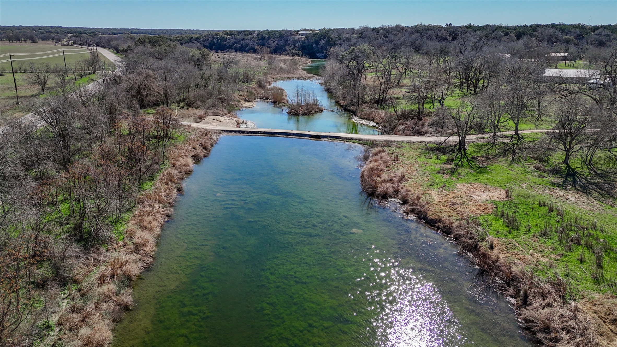 Bird's eye view with a water view and a wooded view