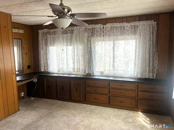 a kitchen with wooden cabinets and a window