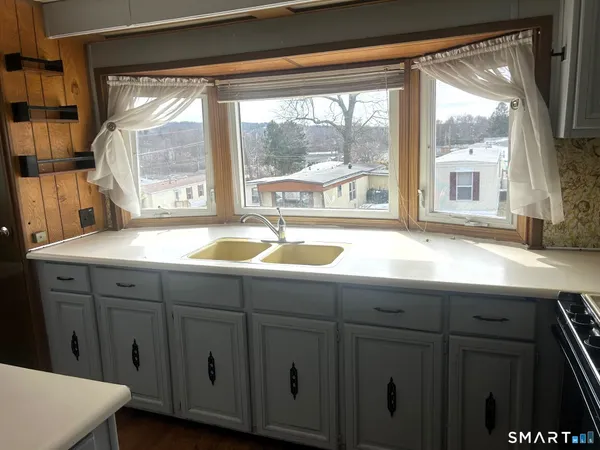 a bathroom with a sink and a large window
