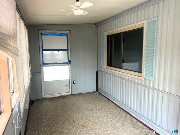 an empty room with windows and closet