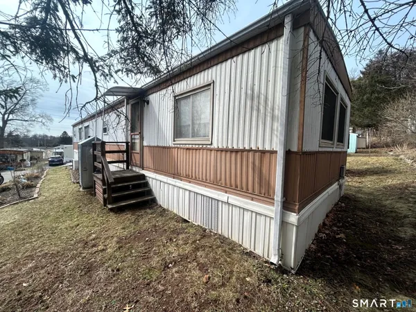 a view of a house with wooden fence