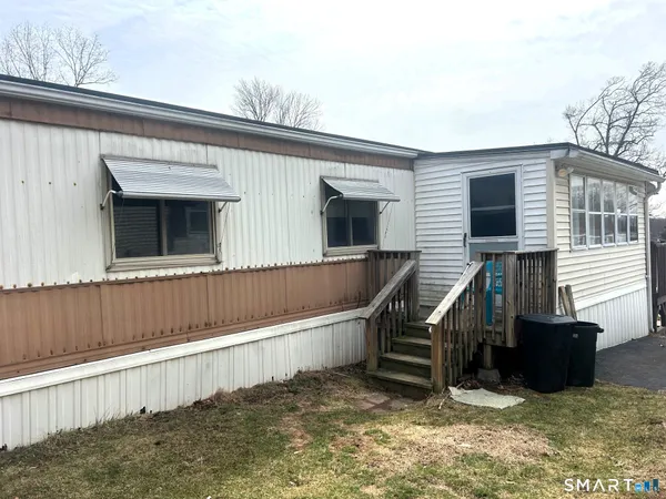 a view of a house with wooden deck