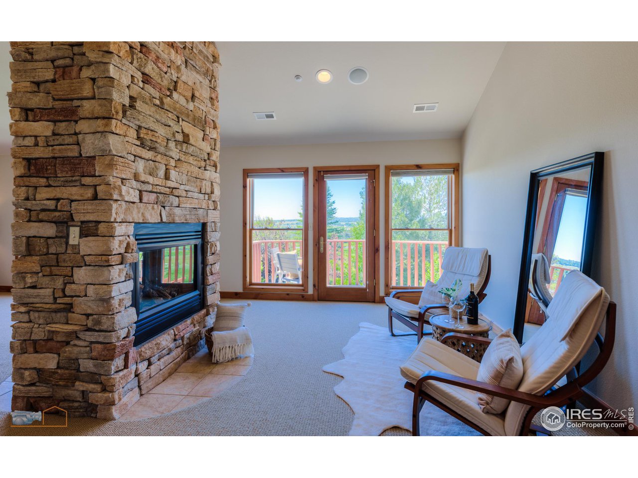 9428 Gunbarrel Ridge Road Boulder, CO 80301 - Photo 19 of 40 Enjoy the fireplace from the sitting area in the primary bedroom.