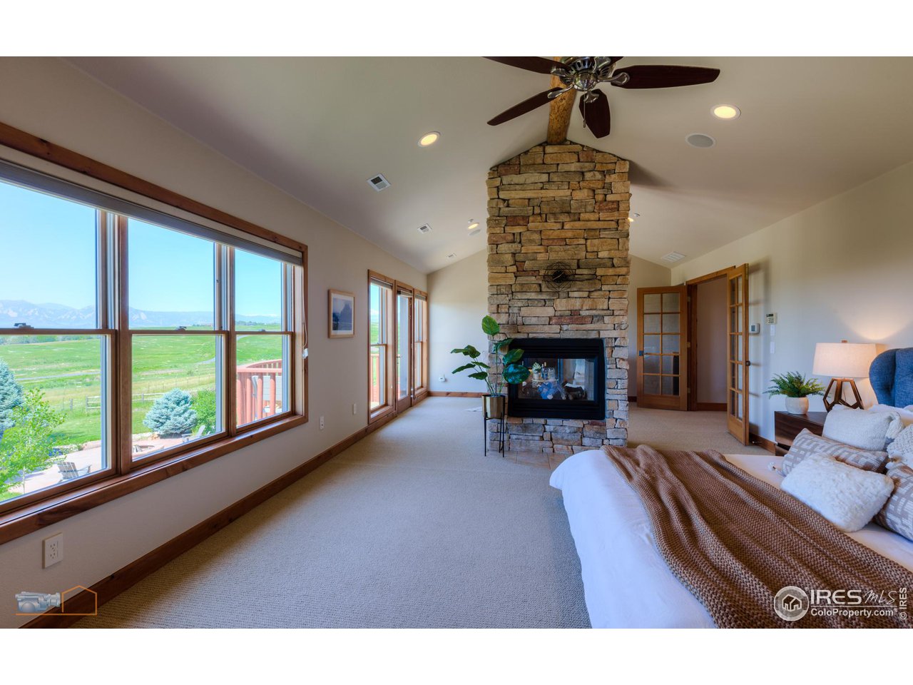 9428 Gunbarrel Ridge Road Boulder, CO 80301 - Photo 22 of 40 Primary bedroom with views and a romantic fireplace