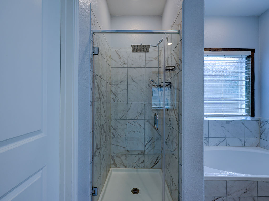 1716 Frontenac Street Leander, TX 78641 - Photo 22 of 34 a bathroom with a shower and a sink
