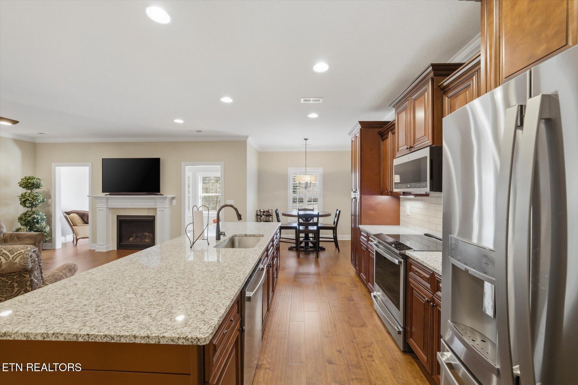 7122 Volunteer Rdg Lane Knoxville, TN 37918 - Photo 14 of 34 a kitchen with stainless steel appliances granite countertop a refrigerator stove top oven dining table and chairs