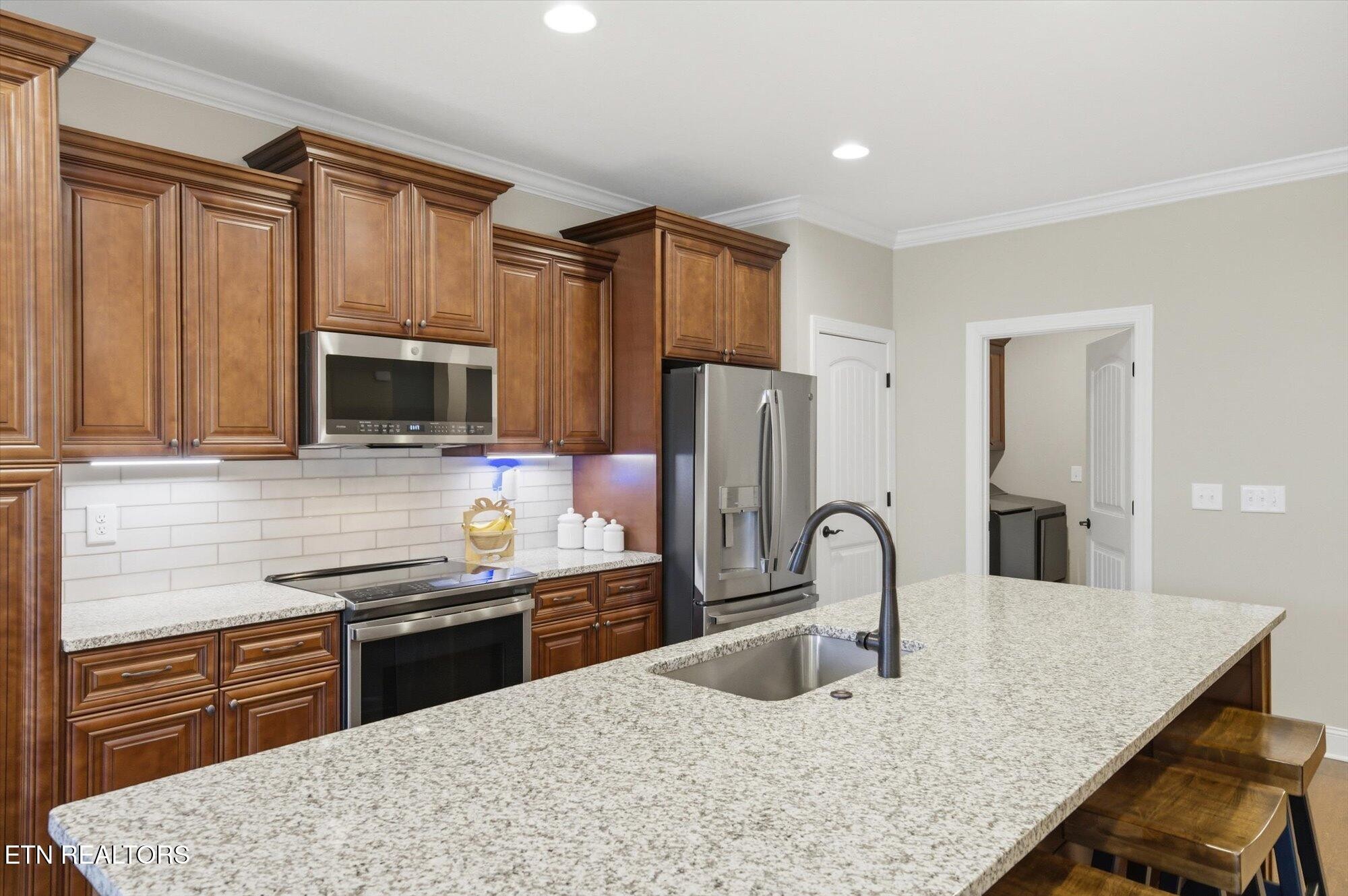 7122 Volunteer Rdg Lane Knoxville, TN 37918 - Photo 15 of 34 a kitchen with stainless steel appliances granite countertop a sink refrigerator and microwave