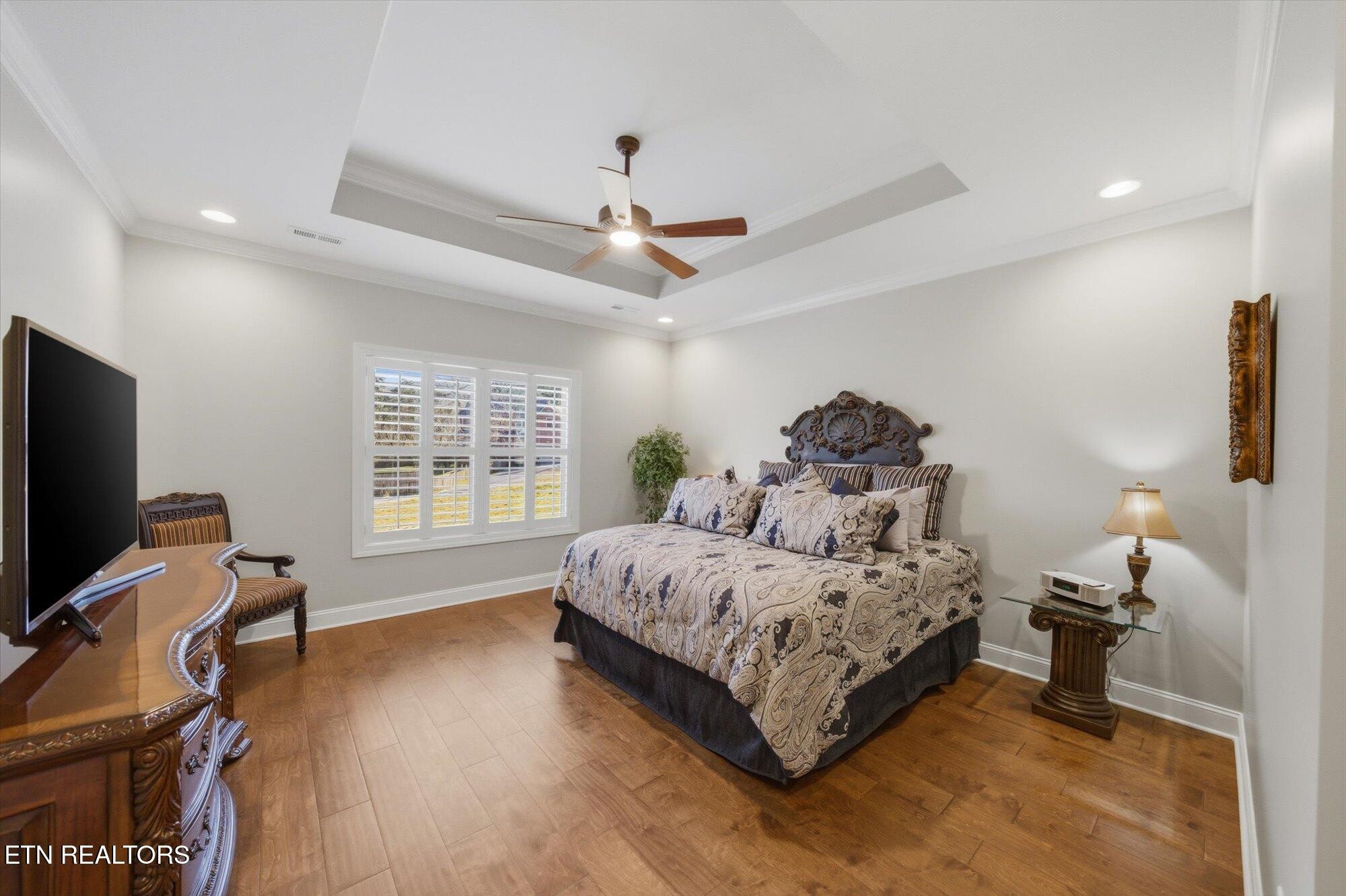 7122 Volunteer Rdg Lane Knoxville, TN 37918 - Photo 19 of 34 a spacious bedroom with a bed and a flat screen tv