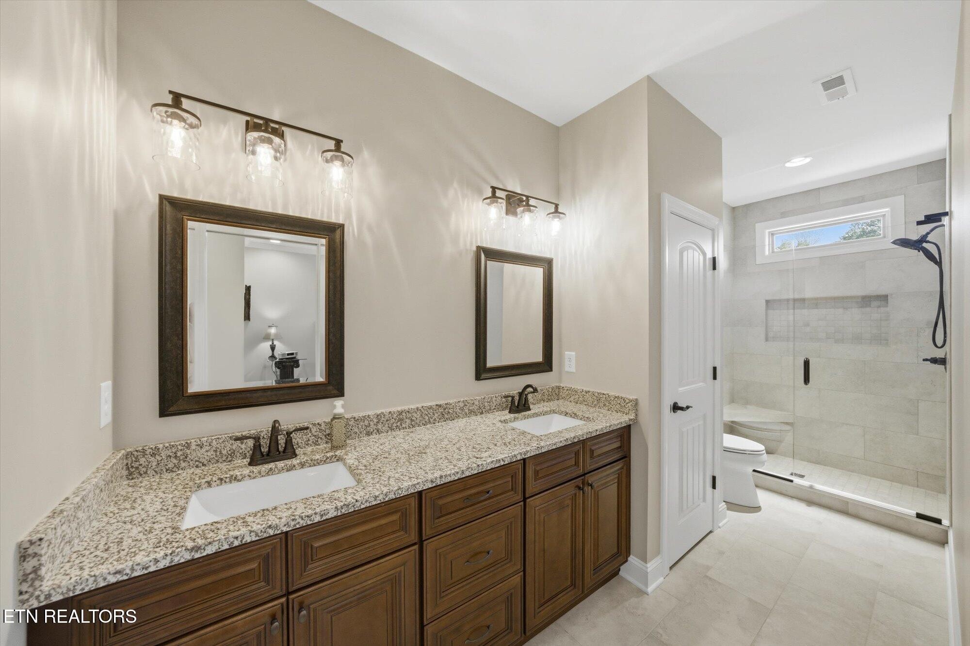 7122 Volunteer Rdg Lane Knoxville, TN 37918 - Photo 21 of 34 a bathroom with a granite countertop double vanity sink mirror double and shower