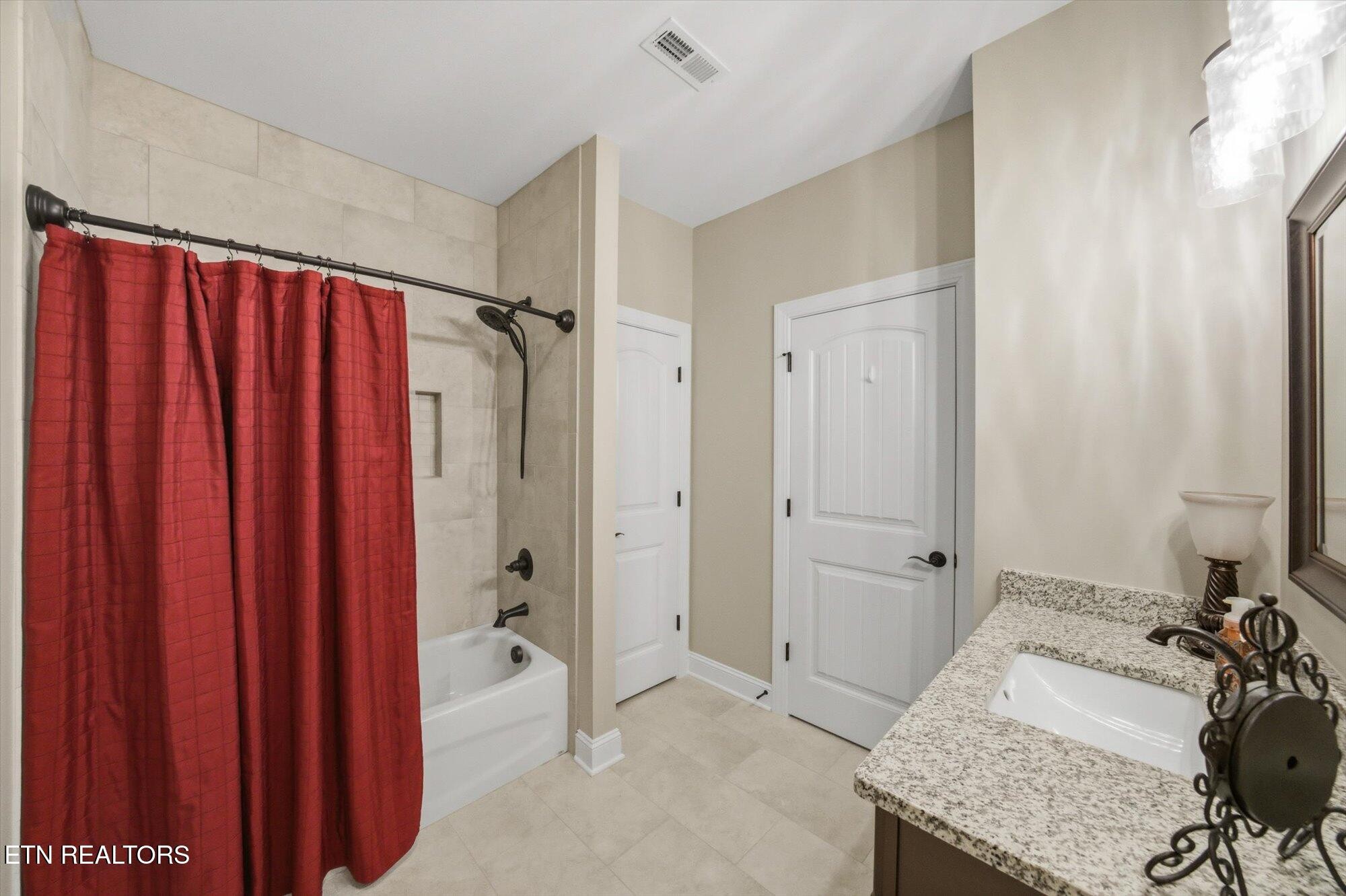 7122 Volunteer Rdg Lane Knoxville, TN 37918 - Photo 26 of 34 a bathroom with a granite countertop sink and a shower