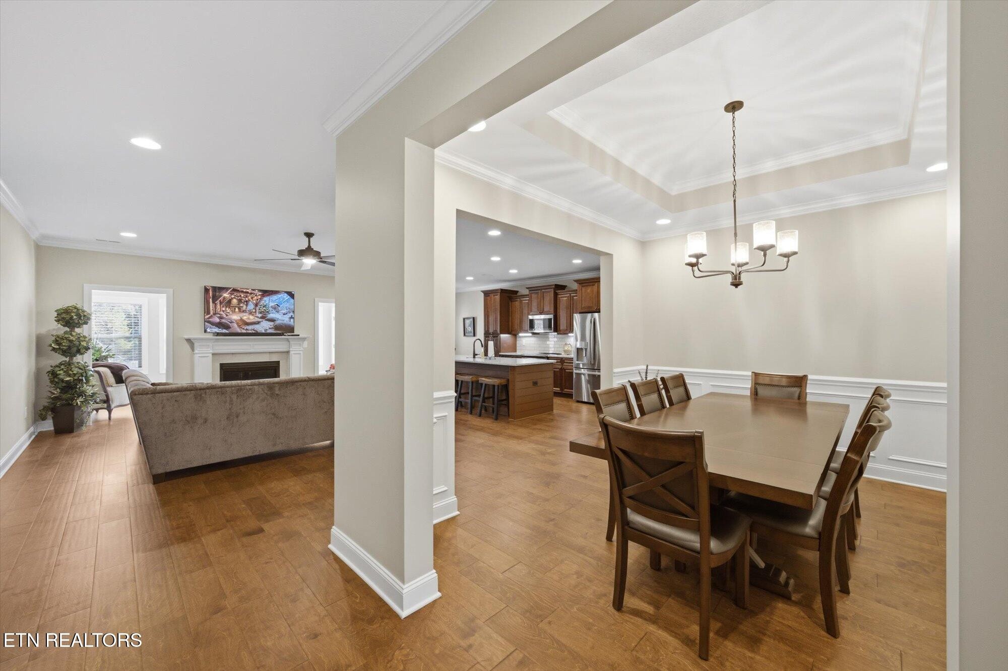 7122 Volunteer Rdg Lane Knoxville, TN 37918 - Photo 6 of 34 a view of a dining room and livingroom with furniture wooden floor and a chandelier