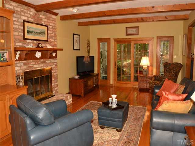 5304 Deep Valley Run Raleigh, NC 27606 - Photo 2 of 25 Large sunken great room, like the rest of the main floor, has beatiful hardwood floors. Gorgeous built-in cabinets and masonry fireplace create a warmly elegant ambiance. Den/Family/Great Room
