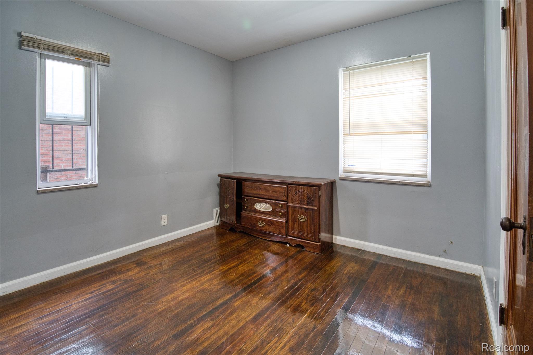 13644 Castleton Street Detroit, MI 48227 - Photo 8 of 18 Wood-finish flooring with white trim and light gray walls