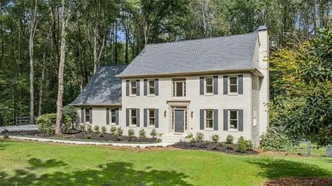 a living room with furniture and view of kitchen