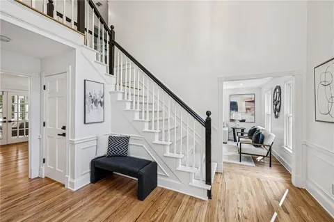 a living room with furniture a fireplace and a large window