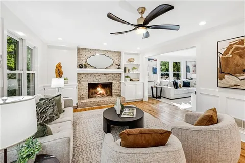 a kitchen with stainless steel appliances granite countertop a refrigerator and a dining table