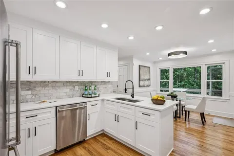a dining room with furniture potted plants and wooden floor