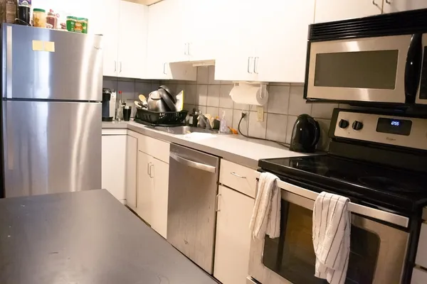 a kitchen with stainless steel appliances a refrigerator stove and microwave