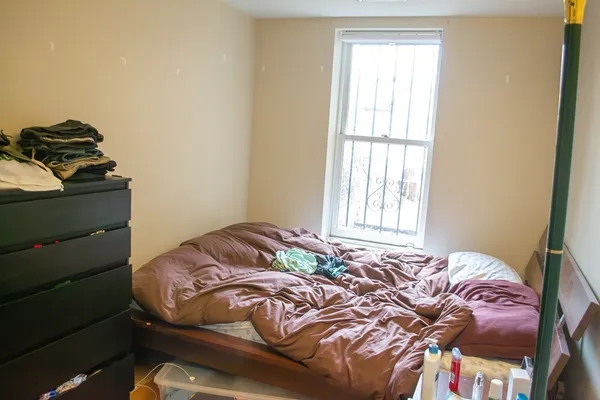 a bedroom with a bed and a window