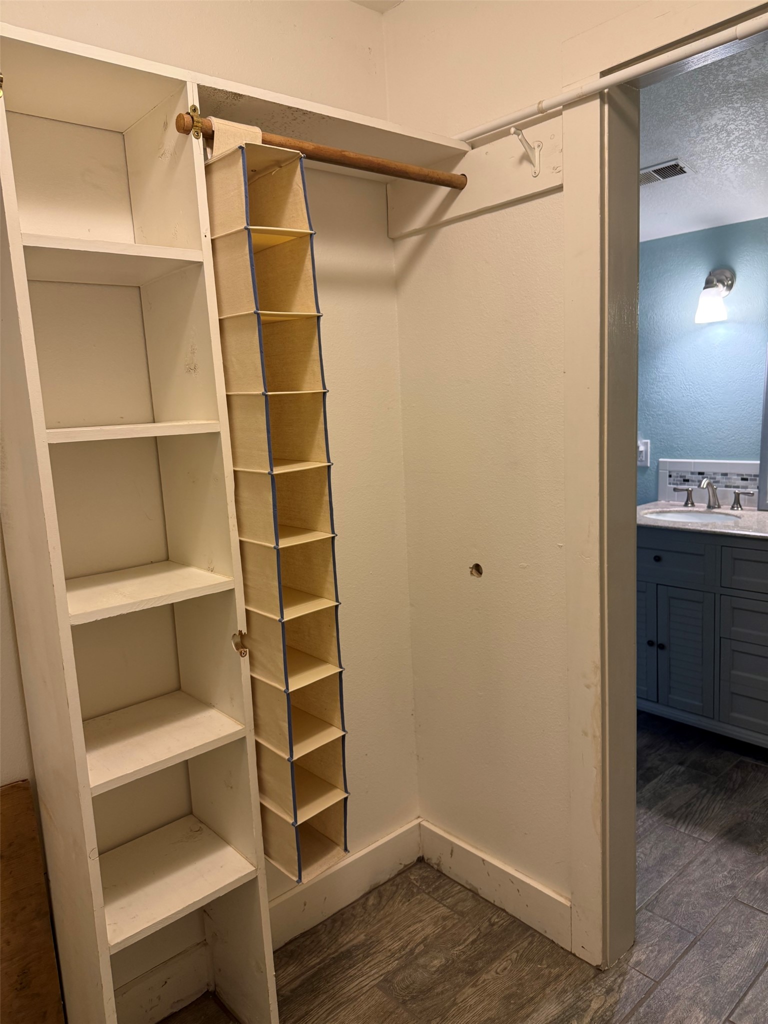 363 Porter Road Bastrop, TX 78602 - Photo 23 of 37 A functional walk-in closet features built-in shelving and direct access to an adjacent bathroom.