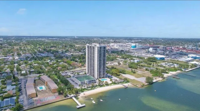 an aerial view of a residential houses with city view