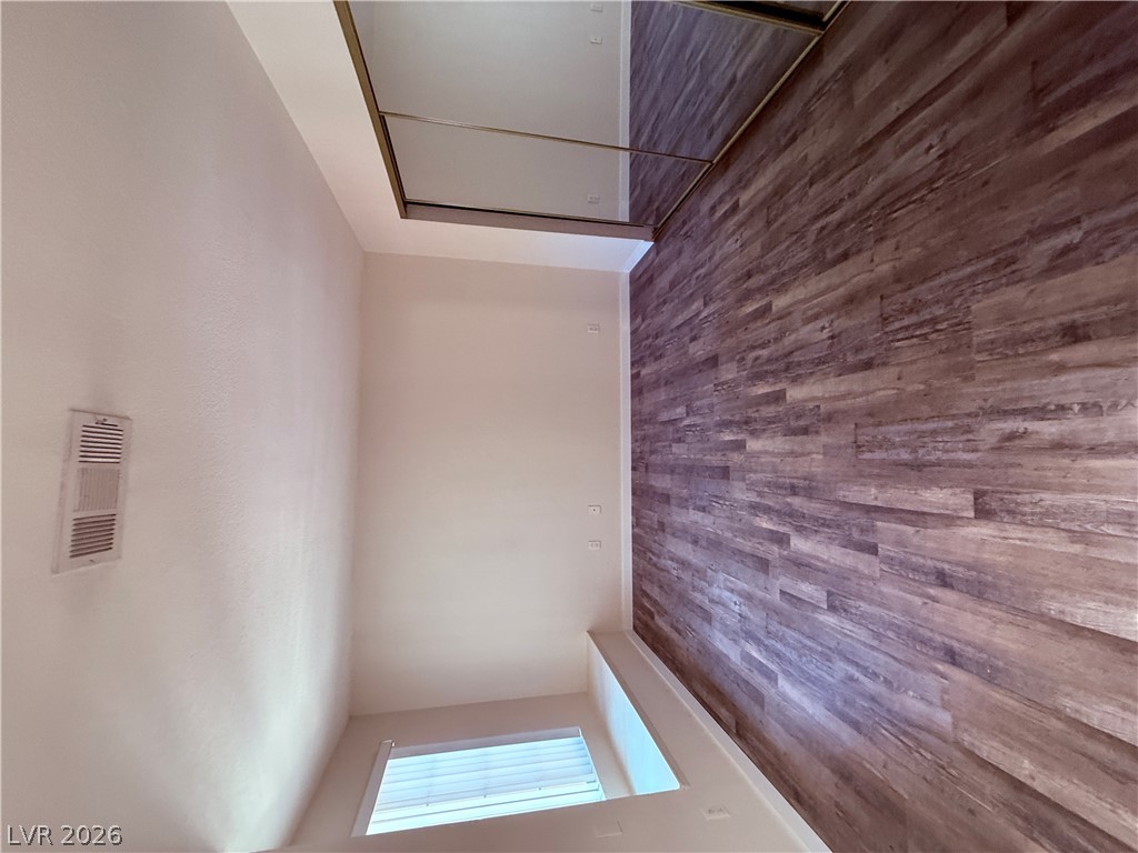 9325 West Desert Inn Road, Unit 260 Las Vegas, NV 89117 - Photo 19 of 42 Rich hardwood-style flooring extends into a sleek closet with mirrored doors.